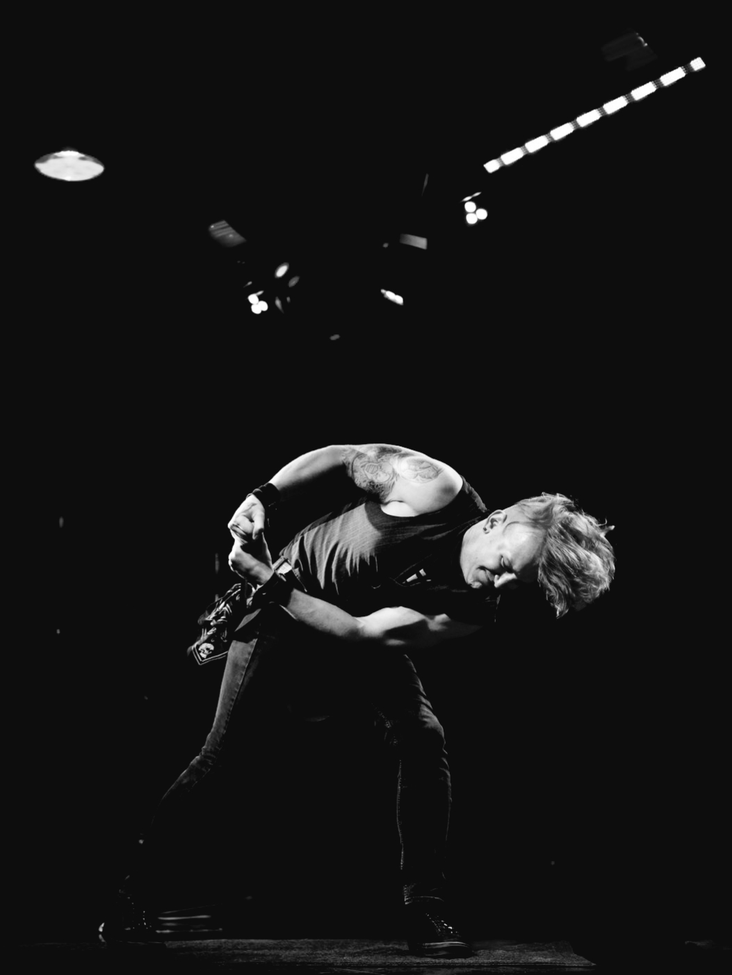 Black and white photo of circus performer Reid Wilson demonstrating strength and flexibility on stage