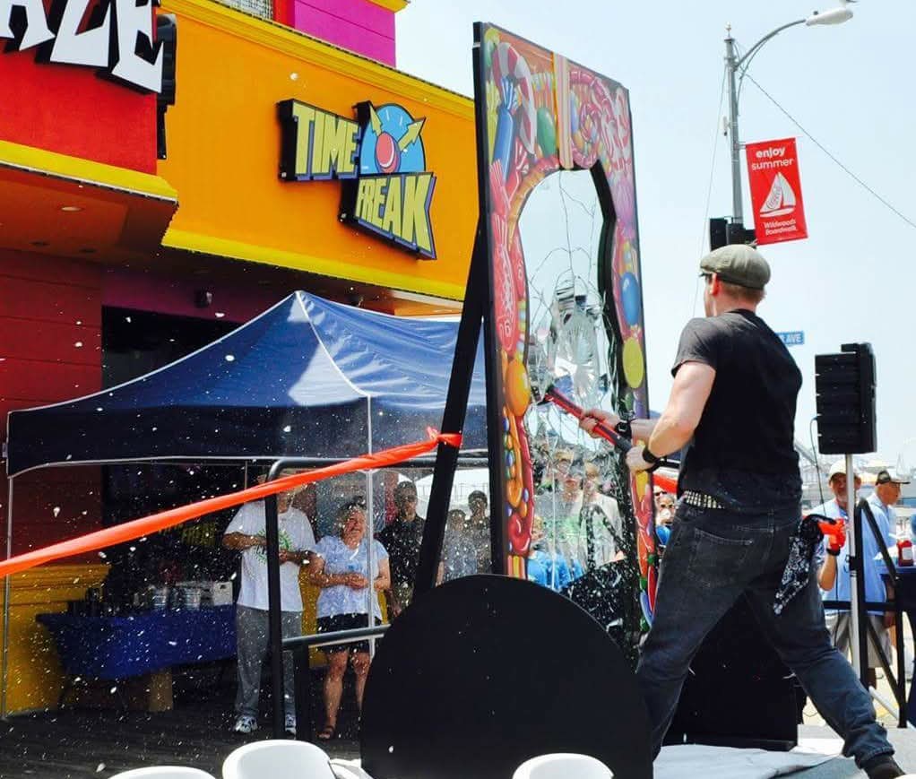 Reid Wilson at outdoor Time Freak boardwalk event bending steel with crowd watching